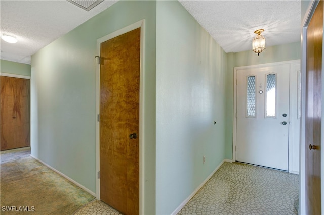 entryway with a textured ceiling