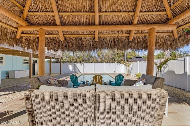 view of patio featuring a gazebo, an outdoor hangout area, and a fenced in pool