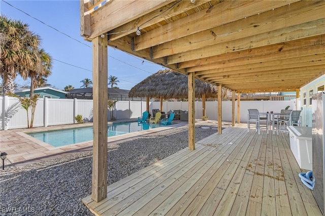 deck with a fenced in pool and a patio