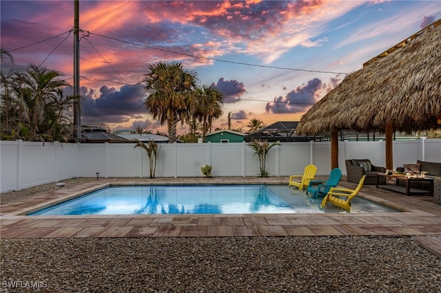 pool at dusk with a patio