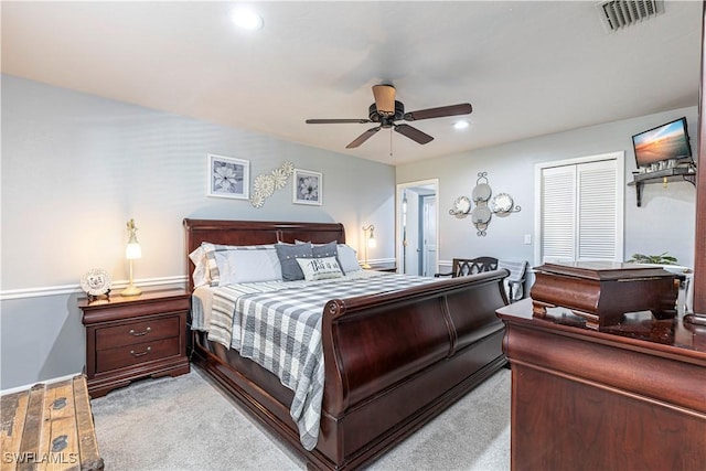 carpeted bedroom with ceiling fan and a closet