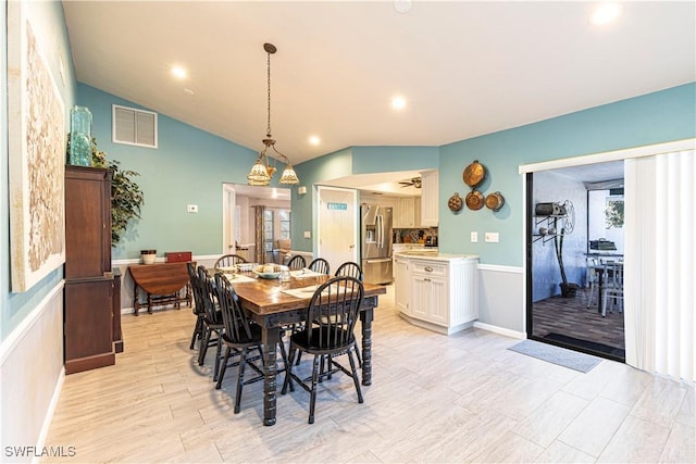 dining space with plenty of natural light, light wood-type flooring, and lofted ceiling