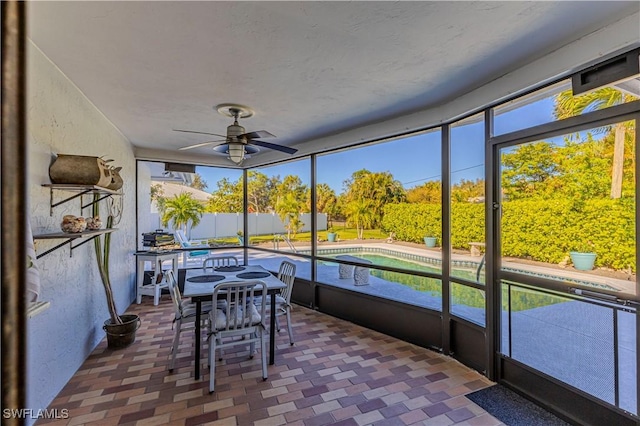 sunroom featuring ceiling fan