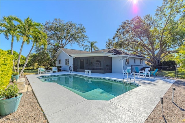 view of pool with a patio and a sunroom