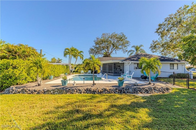 view of swimming pool featuring a patio area, a sunroom, and a yard