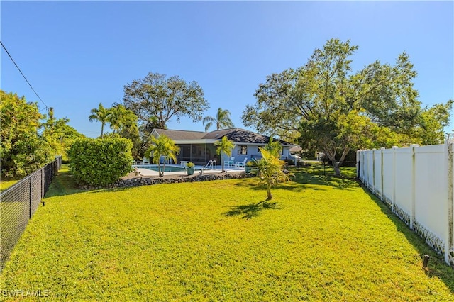 view of yard featuring a fenced in pool and a patio