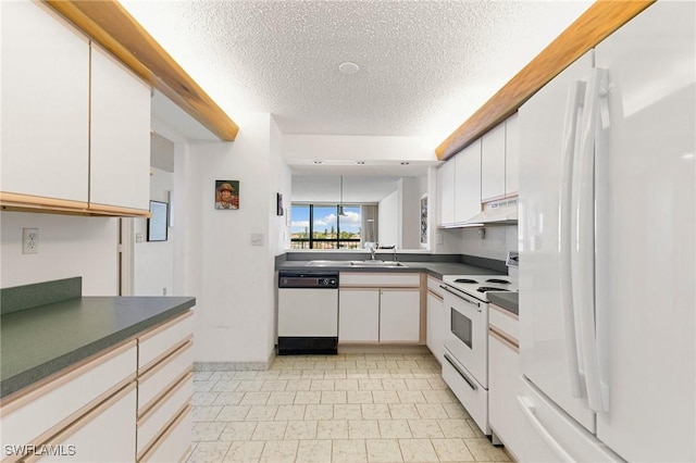 kitchen featuring white appliances, sink, white cabinets, and a textured ceiling