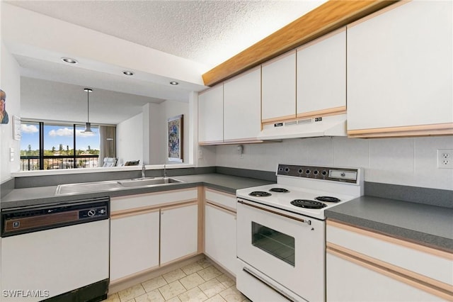 kitchen featuring a textured ceiling, sink, white appliances, and white cabinets