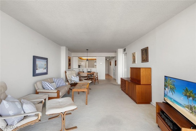 living room featuring a textured ceiling and light colored carpet