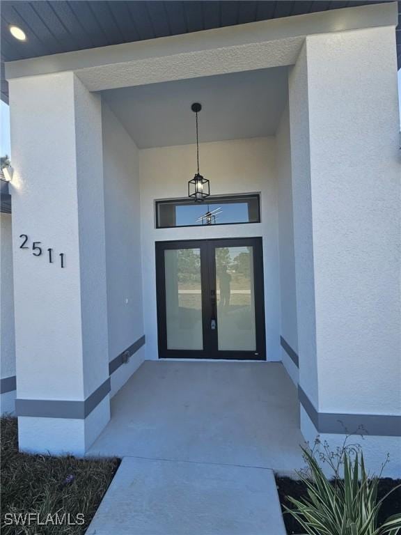 view of exterior entry featuring french doors