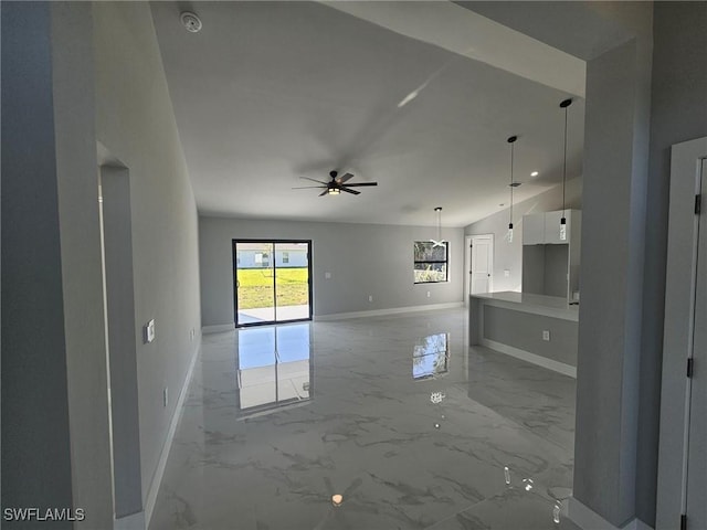 unfurnished living room featuring ceiling fan and lofted ceiling