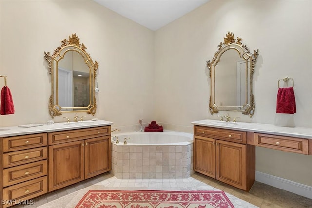 bathroom featuring tile patterned floors, a relaxing tiled tub, and vanity