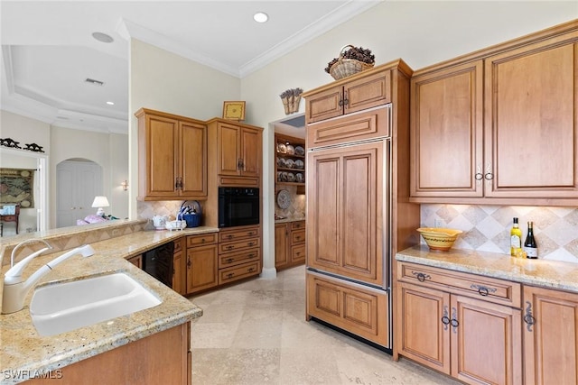 kitchen featuring light stone countertops, tasteful backsplash, crown molding, black appliances, and sink