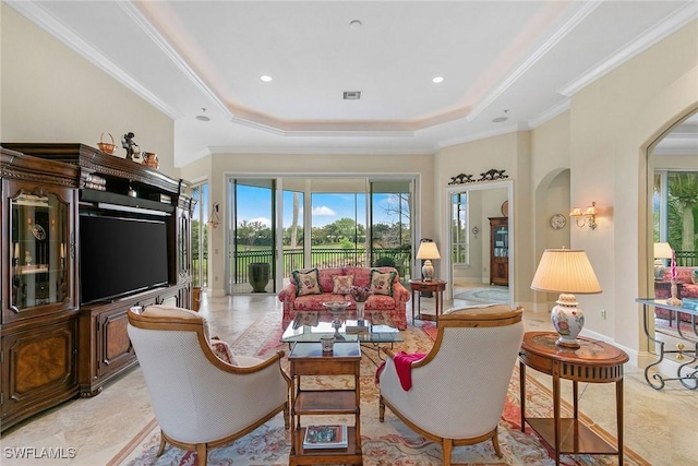 interior space with a raised ceiling and crown molding