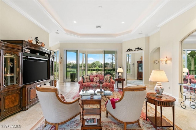 sitting room with a tray ceiling and crown molding