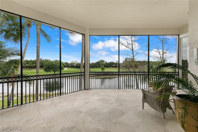 unfurnished sunroom with a water view and a healthy amount of sunlight