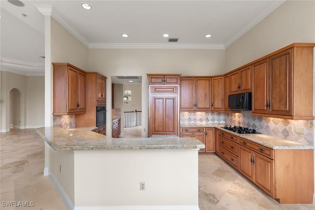 kitchen with light stone counters, brown cabinets, a peninsula, arched walkways, and black appliances