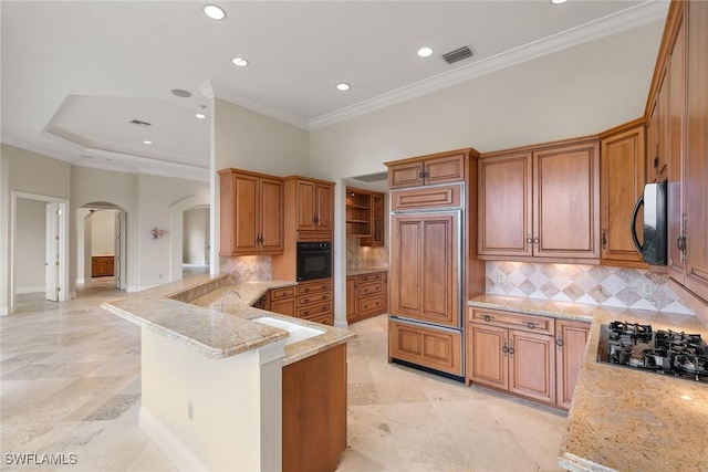 kitchen featuring light stone countertops, visible vents, arched walkways, black appliances, and brown cabinets