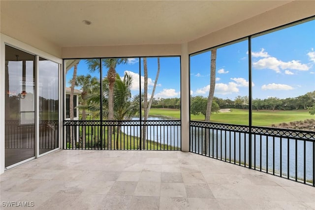 unfurnished sunroom featuring a healthy amount of sunlight and a water view