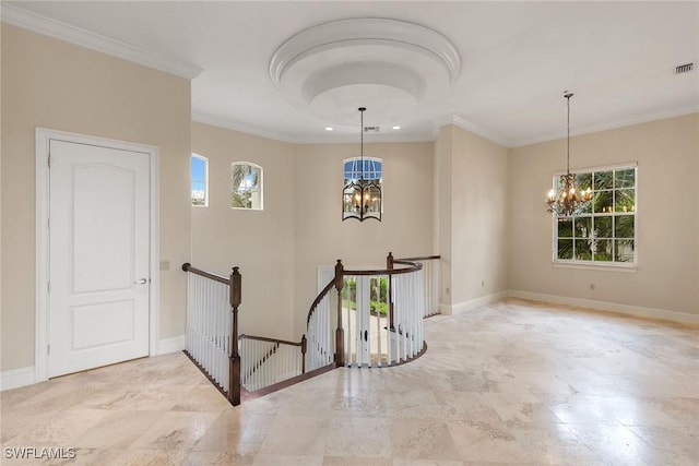 interior space with baseboards, an inviting chandelier, and ornamental molding