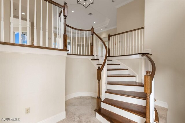 staircase with visible vents, baseboards, a chandelier, recessed lighting, and a high ceiling