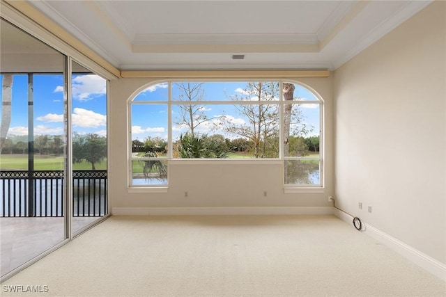 unfurnished sunroom featuring a raised ceiling and a water view