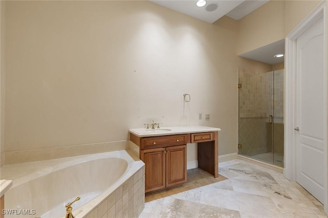 full bath featuring vanity, a bath, baseboards, and a stall shower