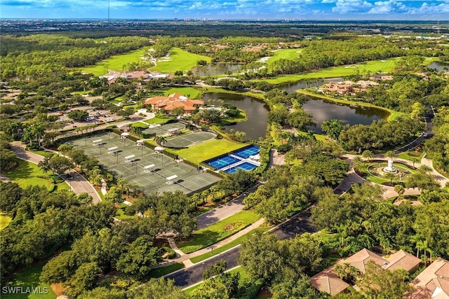 drone / aerial view featuring a view of trees and a water view