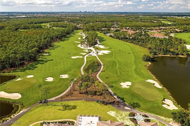 birds eye view of property with golf course view, a forest view, and a water view