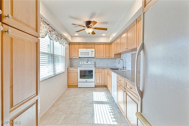 kitchen with sink, light stone counters, light tile patterned floors, white appliances, and backsplash