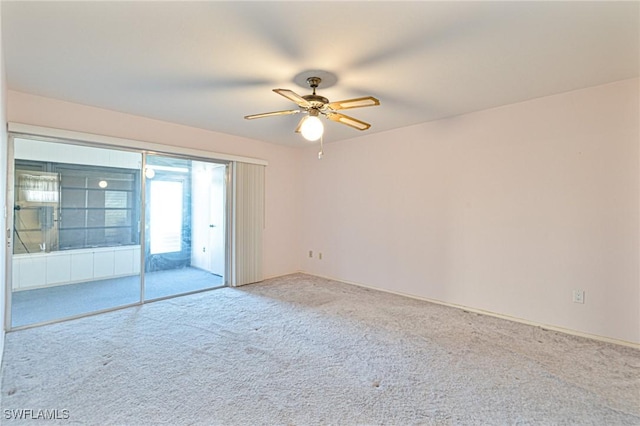 unfurnished room featuring light carpet and ceiling fan