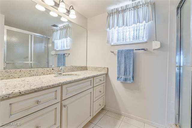 6102 Augusta Dr Unit 103, Fort Myers, FL 33907 - bathroom with tile patterned floors, vanity, a shower stall, and baseboards