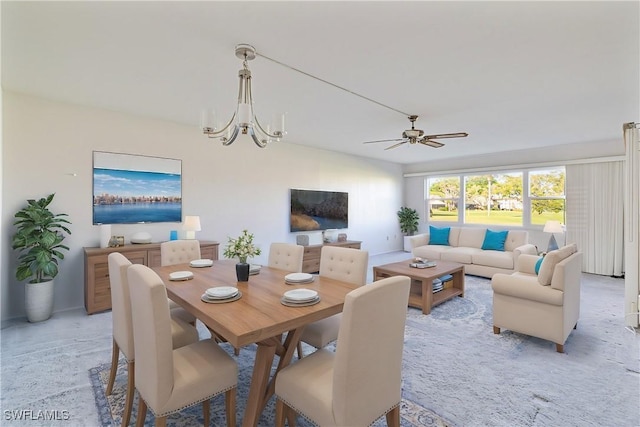 dining space featuring light carpet and ceiling fan with notable chandelier