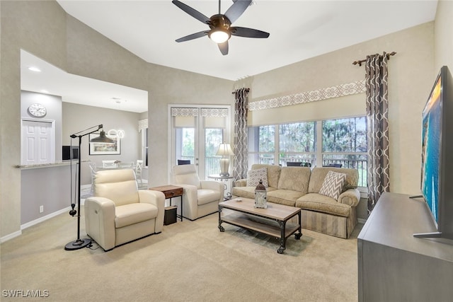 living room with high vaulted ceiling, a wealth of natural light, light colored carpet, and ceiling fan