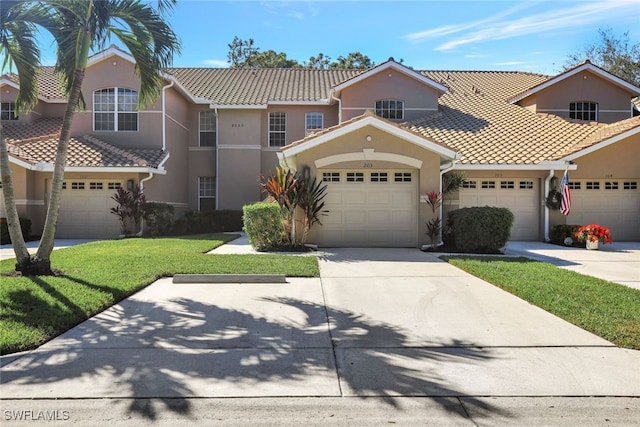 mediterranean / spanish-style house with a garage and a front yard