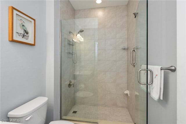 bathroom with toilet and walk in shower