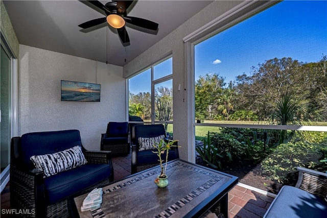 sunroom featuring ceiling fan