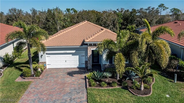 view of front of house with a garage and a front lawn