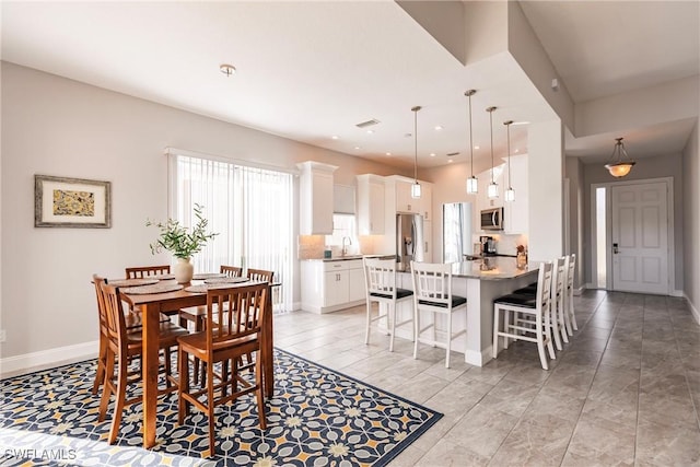 dining area with baseboards and recessed lighting