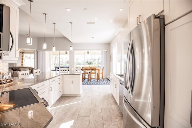 kitchen featuring pendant lighting, stainless steel appliances, plenty of natural light, and white cabinets