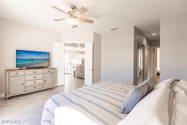 bedroom featuring ceiling fan, baseboards, visible vents, and light wood-style floors