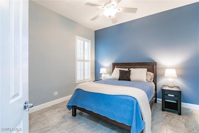 bedroom with ceiling fan and baseboards