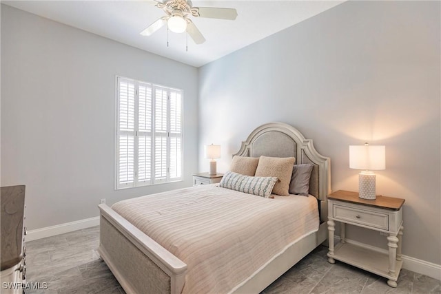 bedroom with a ceiling fan and baseboards