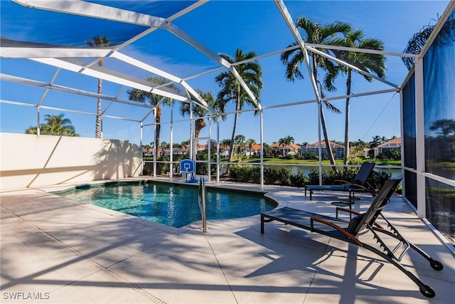 pool featuring a patio, a water view, and a lanai