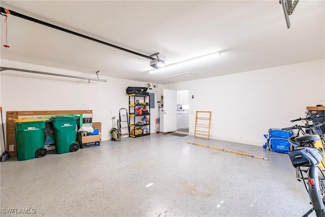 garage featuring washer / dryer and a garage door opener