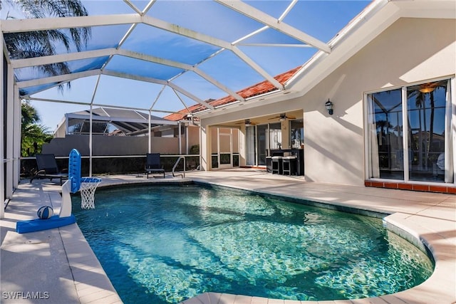 view of swimming pool featuring a lanai, a patio area, ceiling fan, and a fenced in pool