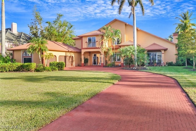 mediterranean / spanish-style home featuring a front lawn