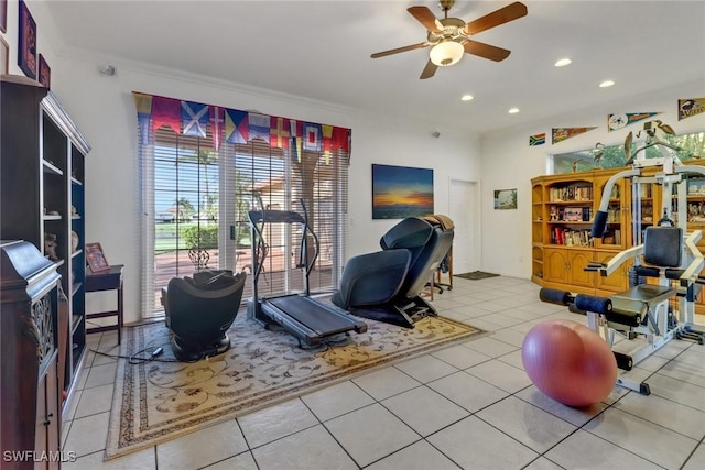 exercise room with light tile patterned flooring, ceiling fan, and ornamental molding