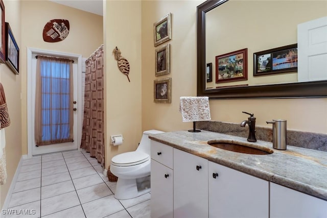 bathroom with tile patterned flooring, vanity, and toilet