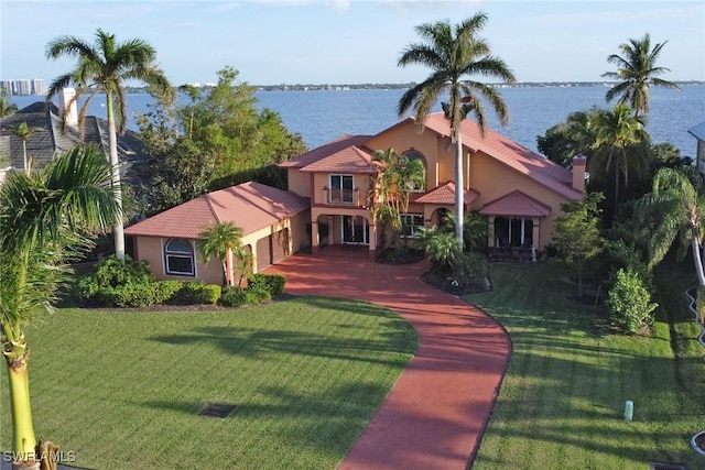 view of front of home featuring a front yard and a water view